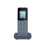 A cordless Grandstream landline phone with a digital screen displaying the time and date, placed on its charging dock.