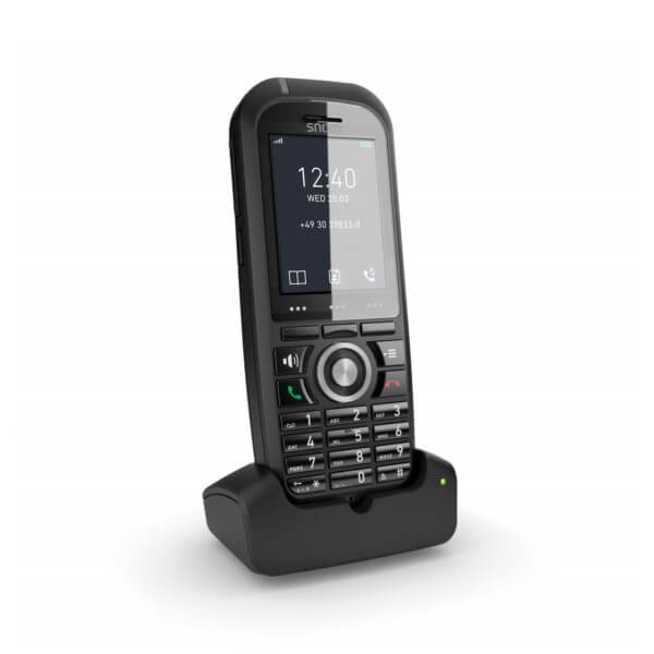 Cordless Phone on Dock::A sleek black cordless phone placed on its charging dock, displaying the time and date on the screen.