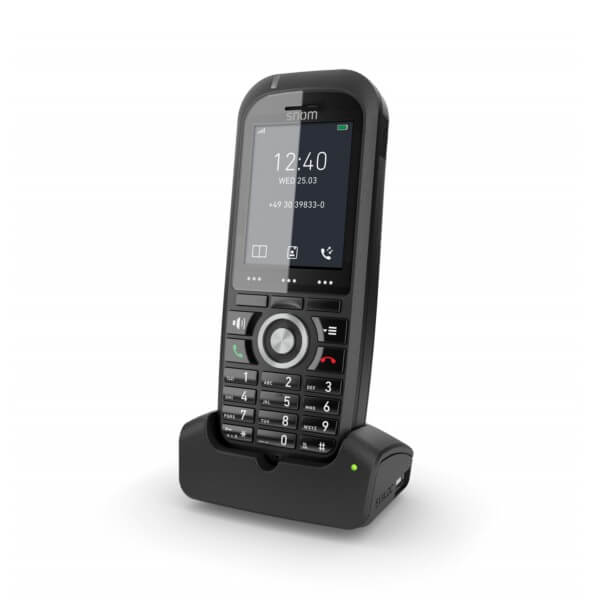 A sleek Snom D712 cordless phone placed on its charging dock, displaying the time and date on the screen.