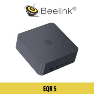 A Beelink EQR5 device showcased on a table in a modern Dubai setting, with cityscape views visible in the background.