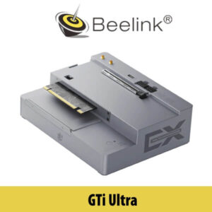 A close-up image of the Beelink GTI Ultra computer model displayed on a table with Dubai's skyline subtly visible in the background.