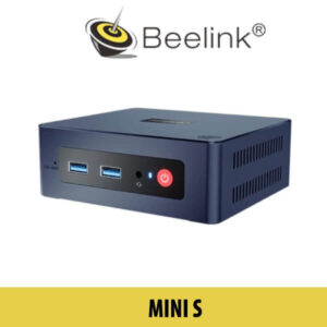 Beelink Mini S device showcased on a table at Dubai Expo, featuring a sleek design with a small form factor and various ports visible on the side.