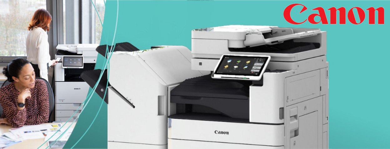 Canon Multifunction Printer in Office Setting A modern Canon multifunction printer with a touchscreen interface, placed in a well-lit office environment, while two women engage in a discussion over papers.