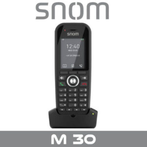 A front view of the Snom M30 wireless VoIP phone on its charging dock, displaying the screen with the time and date.
